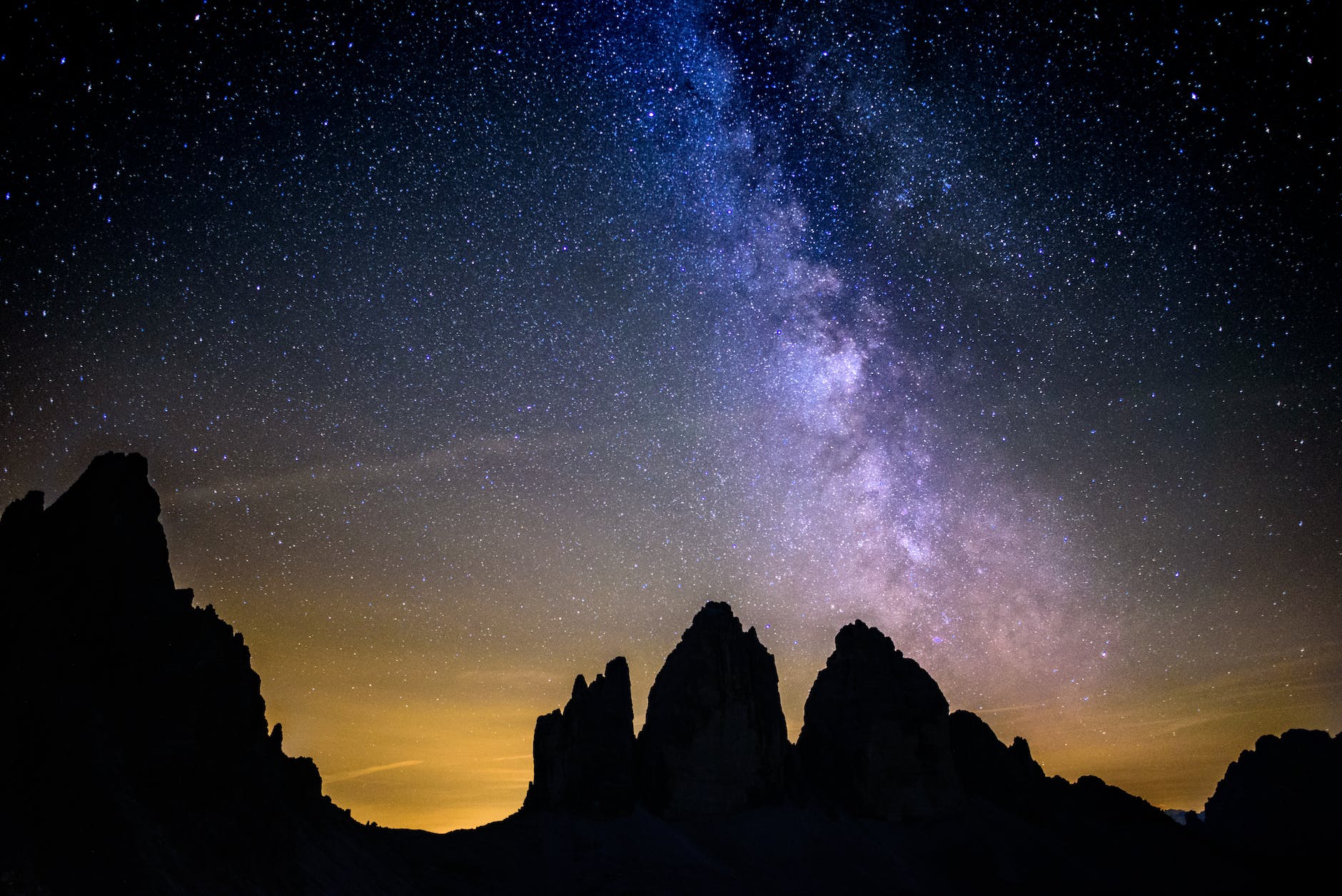 silhouette photography of rocky mountains under starry sky